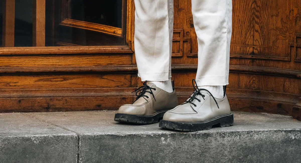 Close-up of stylish shoes and trousers in an urban setting, Graz, Austria.