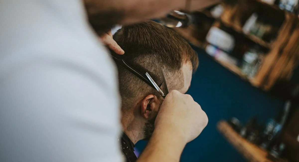 Haircut scene in a Polish barber shop capturing the art of modern grooming and styling.
