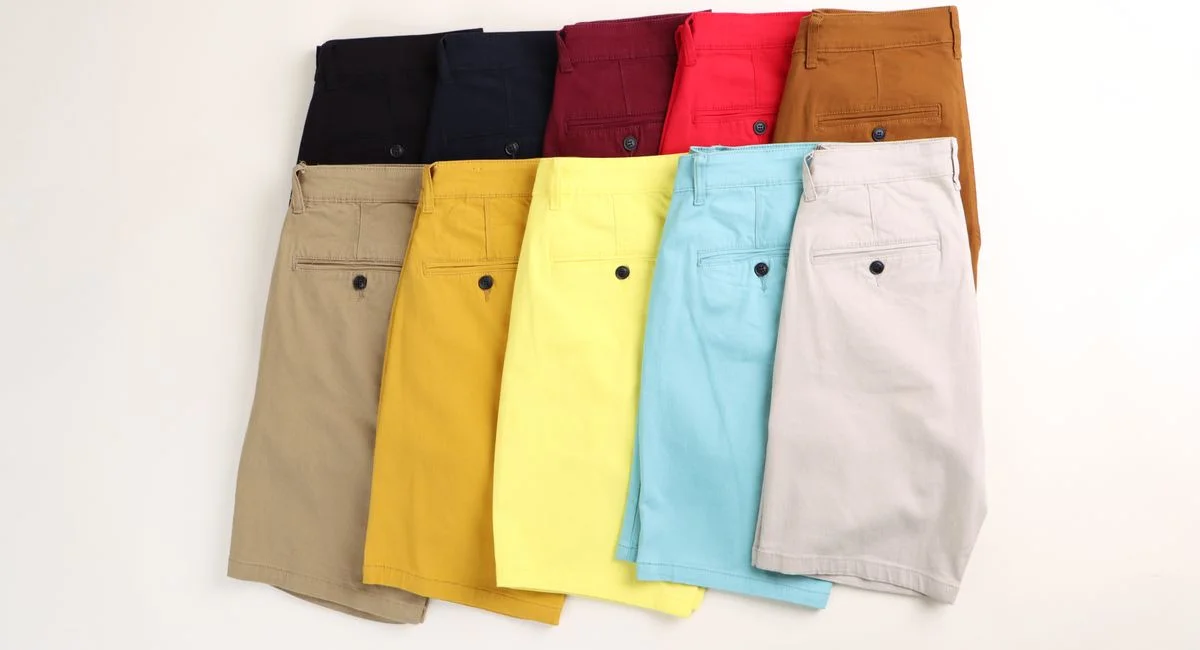 Flat lay of colorful men's shorts in different styles and colors, ideal for summer fashion.