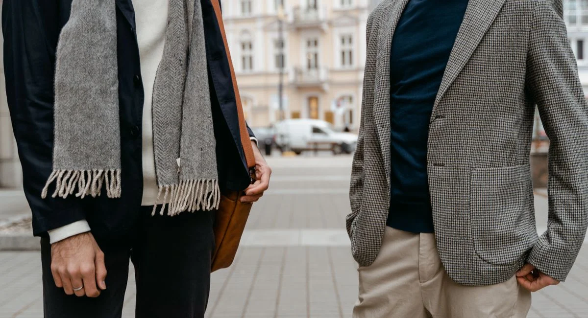 Two men in stylish business attire on a city street. Modern and elegant fashion.